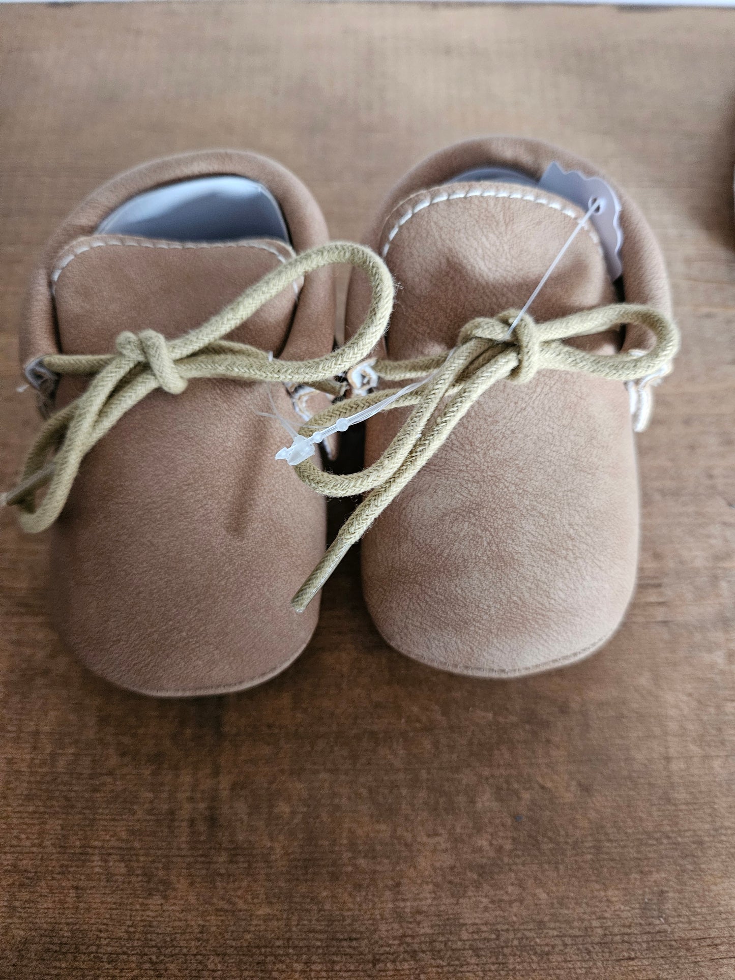 Tan tied moccasins