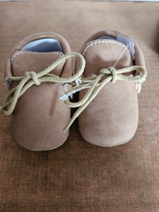 Tan tied moccasins