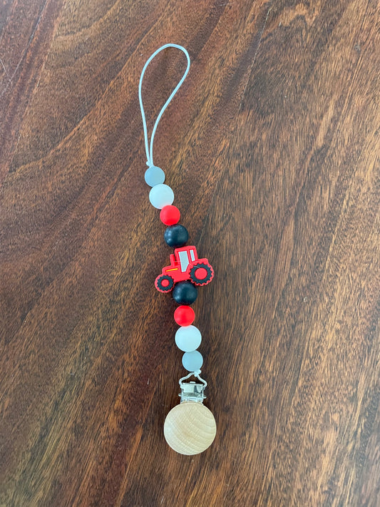 Red tractor binky clip